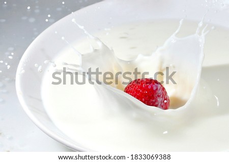 Time Lapse  Photography Of Strawberry Falling On Milk.