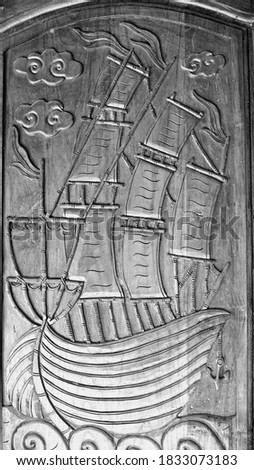 Wood carving boat pattern on black and white background, wooden door, with fish texture carving, vintage decoration.