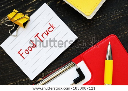 Business concept meaning Food Truck  with sign on the piece of paper.
