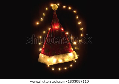 Christmas yellow lights on Santa's hat, on a black background
