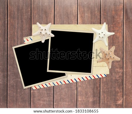 Two retro photos, old postcard, starfish and vintage envelope on old wooden boards. Copy space for text. Mock up template