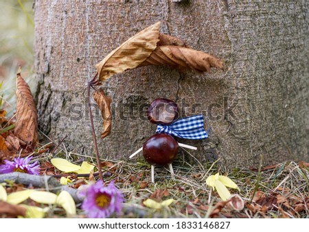 Chestnut man in a scarf is resting under the leaf.