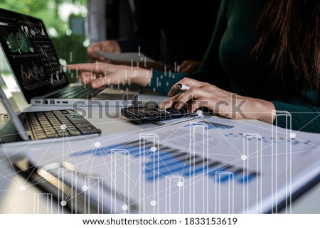 Double exposure of businesswoman hands using tablet and laptop with business financial stock market trading, Technology digital and stock market concept, Background toned image blurred.
