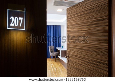 Blurred background, view to a hotel room through open door