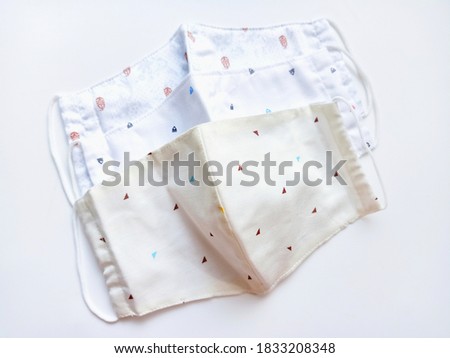 Close-up photo of the washable cotton cloth masks fabric pattern isolated on white background. The fabric face masks for wearing to protect viruses and others when in out in public, new normal.