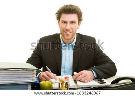 Young man in suit is working at his desk