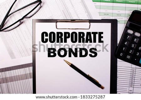 CORPORATE BONDS written on a white piece of paper next to the glasses. reports and calculator. Business concept