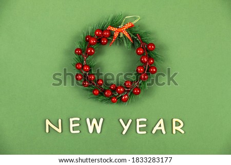 Christmas decorative wreath on green background. New year background. Top view