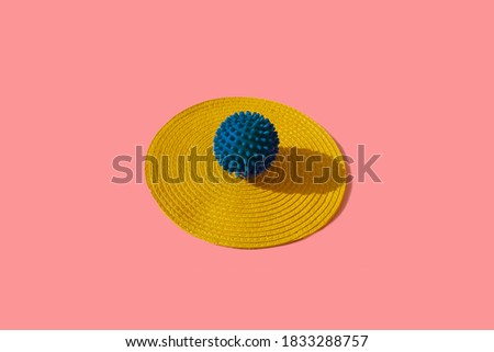 Abstract and conceptual image of blue colored mascot ball or toy on light pink background