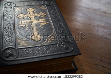 old family bible black book with gold applications, text on cover illustrated family bible          