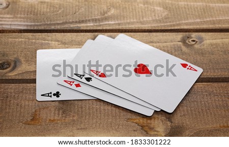 Gambling poker aces, playing cards on wooden plank table background and texture