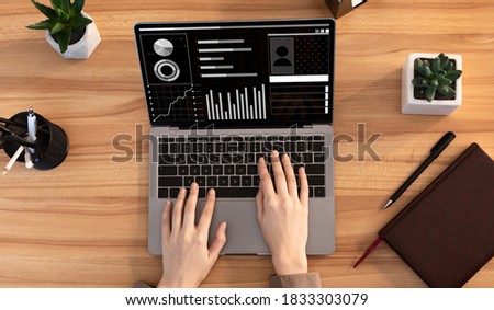 Unrecognizable woman working on computer with business financial graphics on screen, analyzing economic profile statistics data on laptop, sitting at desk in office, creative collage, top view