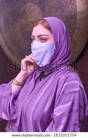 A woman wearing a medical mask. A young Emirati woman wears a medical mask to prevent the Corona virus