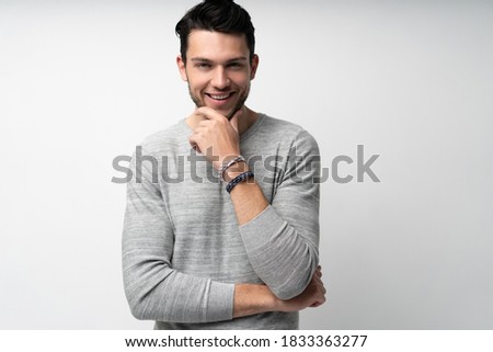 Handsome young man on white background looking at camera. Happy guy smiling