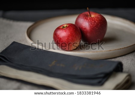Two red apples on the table