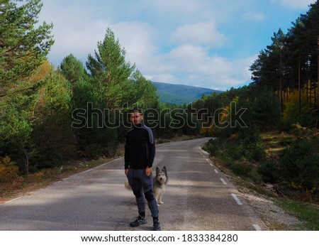young man in the middle of a mountain road 