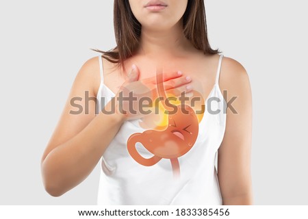 The Photo Of Cartoon Stomach On Woman's Body Against White Background, Acid Reflux Disease Symptoms Or Heartburn, Concept With Healthcare And Medicine Royalty-Free Stock Photo #1833385456