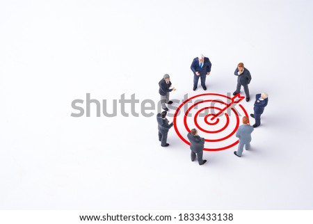 Concentrate setup objectives target and business goal ,Manager miniature figures standing and see in virtual red arrow and dartboard which print screen on white background.