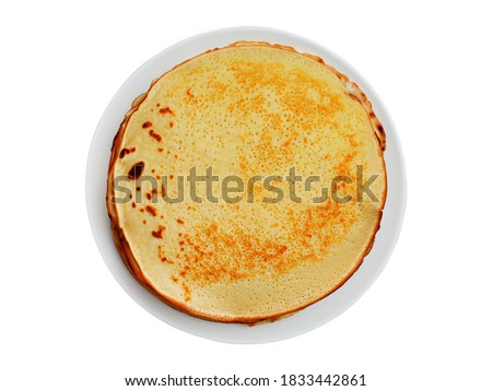 Plate with hot fresh pancakes on a wooden table, close-up view from above