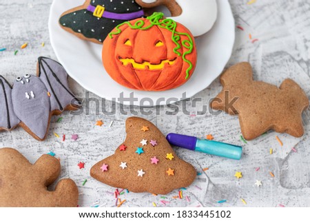 Halloween ginger cookies. Making homemade gingerbread cookies for Halloween. Halloween objects on textured. Funny ginger biscuits. Soft focus.