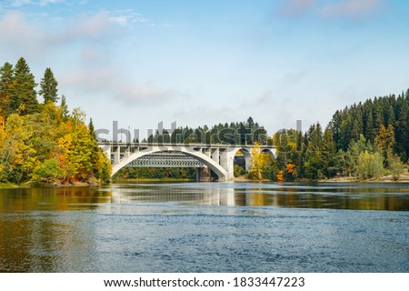 Autumn landscape of bridge and Kymijoki river waters in Finland, Kouvola, Koria Royalty-Free Stock Photo #1833447223