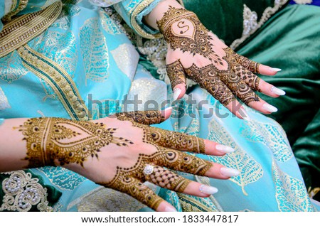 Mehndi tattoo. Woman Hands with black henna tattoos. moroccan national traditions.