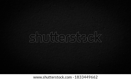Beautiful Abstract Grunge Decorative Navy Black Dark Stucco Wall Background. Image of the dark colored concrete wall has light from the center of the picture. There is space for designing and text.