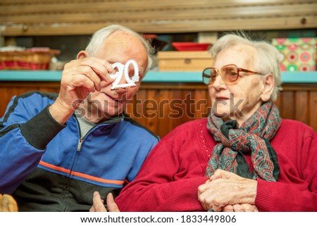 Elderly man celebrates 90th birthday with his wife at home. Family concept.