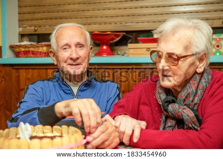 Elderly man celebrates 90th birthday with his wife at home. Family concept.