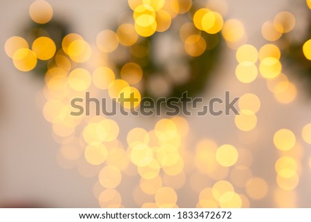 Christmas home room with tree and festive bokeh lighting, blurred holiday background.