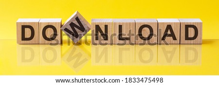 download word written on wood block. corporate text on table, concept. Word download is made of wooden building blocks lying on the table and on a light yellow background.