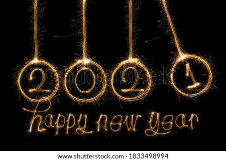 Happy New Year 2021. Sparkling burning text Happy New Year 2021 isolated on black background. 