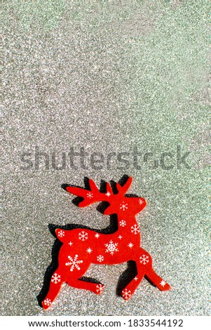 Red new year deer on a silver background. New year and Christmas concept. Selective focus.