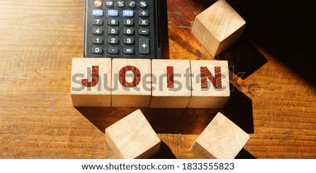 The JOIN sign on wooden block and calculator. Business concept.