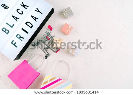 Top view of laptop, black friday promotion sale words on lightbox, gift boxes, laptop , shopping cart and bag, credit bank card on table. Online shopping, Sale, e-shopping, ordering, payment.concept