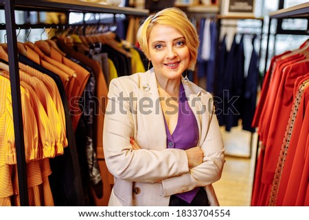 color scheme, decoration, design and people concept - smiling young woman with color swatches or samples helping to choice cloths
