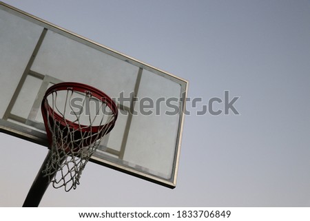 Basketball hoop with a clear sky background at dusk