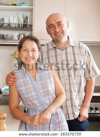 Happy mature woman and adult man at home