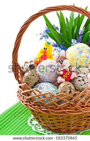Colorful Easter eggs in a basket on a white background