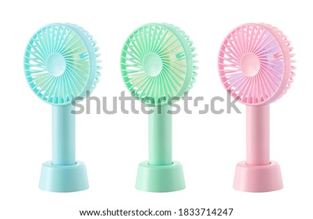 USB rechargeable hand fan on white background Royalty-Free Stock Photo #1833714247