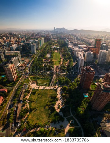 Araucano Park's vertical panoramic view from the air with Santiago city on the background on a sunny day