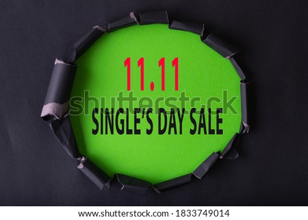 11.11 Single day sale. Black circle torn paper with 11.11 Single days sale on Green color background