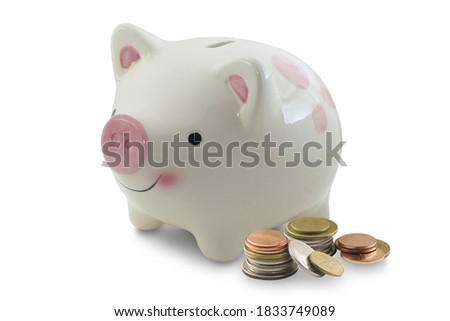 Piggy bank with coins isolated on white background.