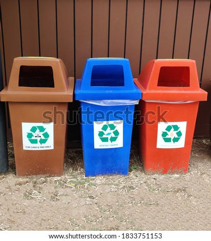 a row of environmental friendly dustbins with recycle icon for garbage segregation. Image may contains noise and grains