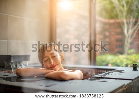 beautiful Young woman relaxing  in hot spring Royalty-Free Stock Photo #1833758125