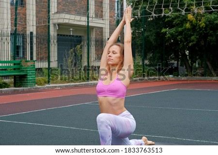 Woman athlete in sportswear practices yoga exercises prayer position. Hands in namaste posture.