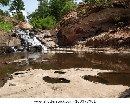 Waterfall and mountain rock in forest