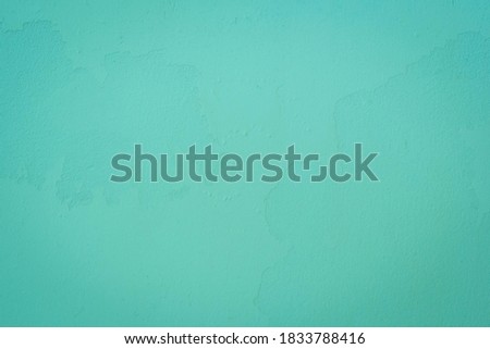 Beautiful Abstract Grunge Decorative Navy Neo – Purist Blue Wall Background. Image of the dark colored concrete wall has light from the top of the picture. There is space for designing and text.
