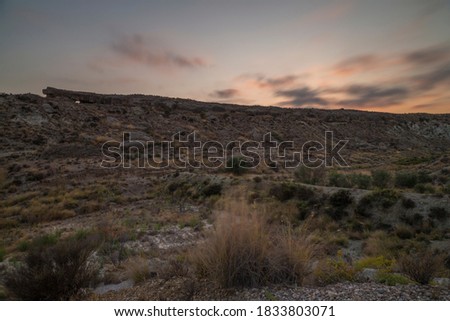 Desert landscape during sunset Long exposure photography with the clouds and movement with pink tones. Concept landscape.