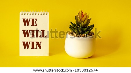 We Will Win, text on notepad, yellow background Royalty-Free Stock Photo #1833812674